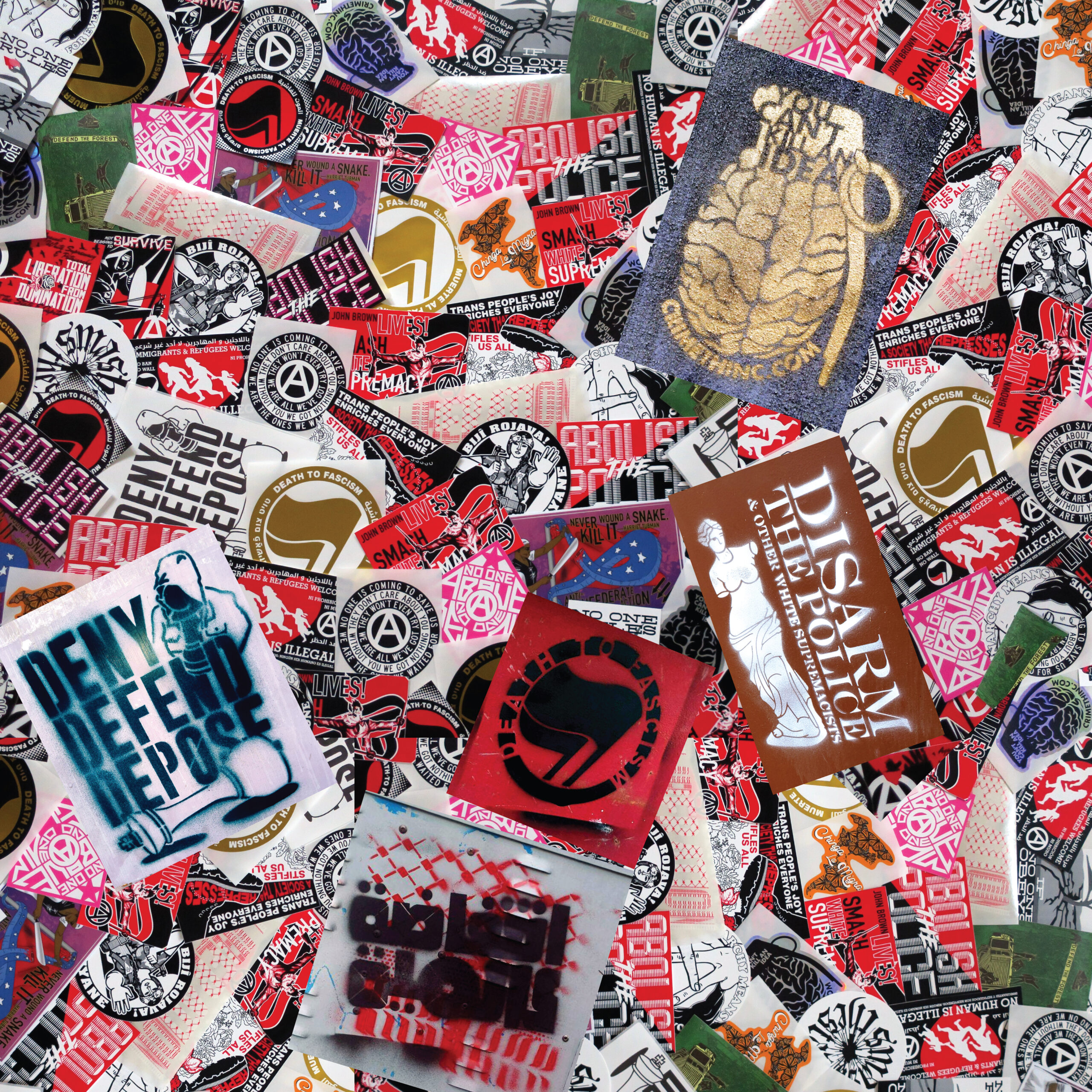 A messy pile of Municipal Adhesives stickers and stencils