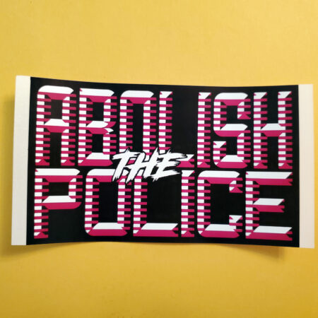 A marigold background with a sticker: black on a white paper backing with the words Abolish the Police in a magenta, retrofuturistic typeface.