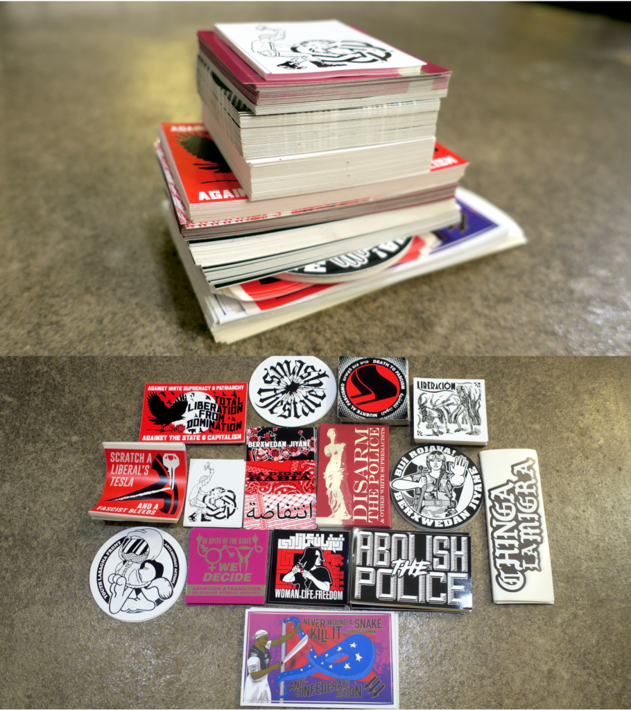 Two pictures stacked on top of one another that show what one might get in a large distro pack: the top pic shows how tall a stack of stickers you would get, the lower pic shows 15 varieties of stickers, in their smaller stacks. These stickers range from Abolish the Police to Youth Lasagna Front.