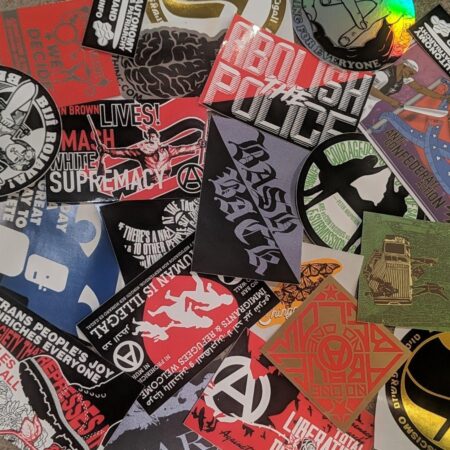 A messy pile of multiple Municipal Adhesives stickers