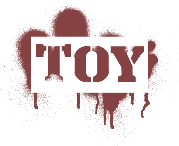 The word "toy" in brown with a lot of overspray.