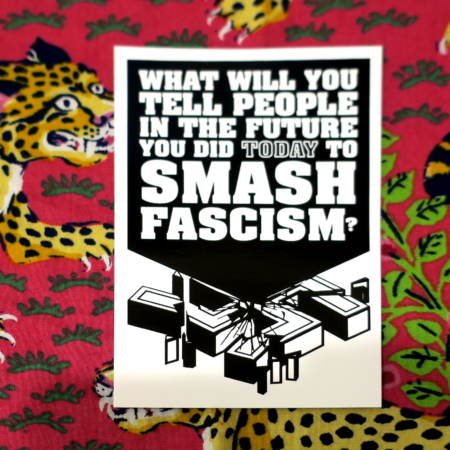 On a magenta background with leopards and ivy, a sticker on which a black wedge smashes into the heart of a shattered 3-dimensional swastika. The words on the black wedge read: What will you tell people in the future you did today to SMASH FASCISM?